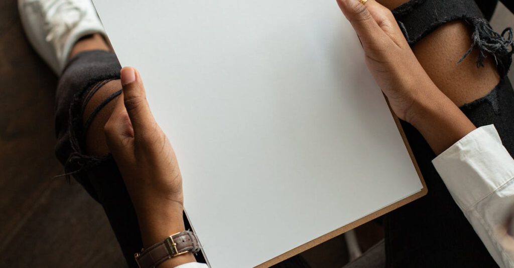 Top view of a person holding a blank clipboard, perfect for mockup designs.